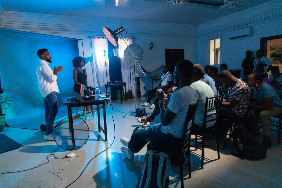 Jameson Thermitus and a co-presenter addressing seated attendees at a photography workshop in Cap-Haïtien, Haiti